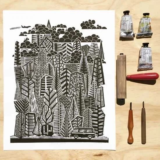 Black-and-white relief print with carving tools and ink tubes